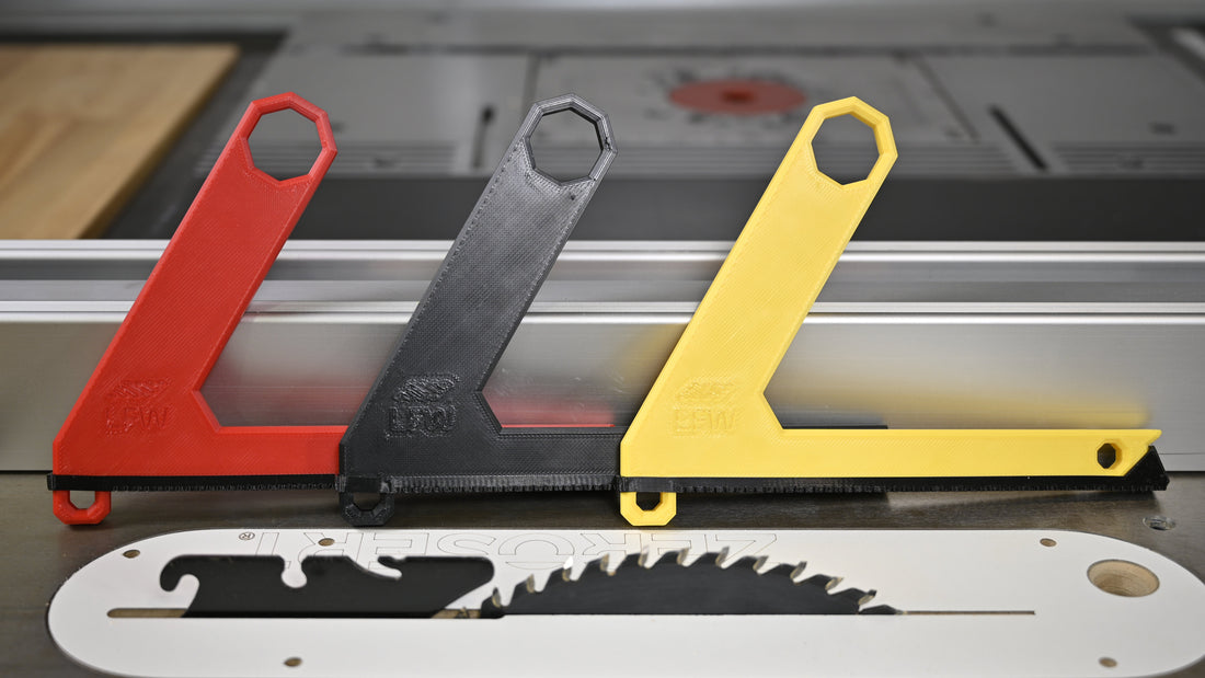 L-shaped push stick guiding a board on a table saw